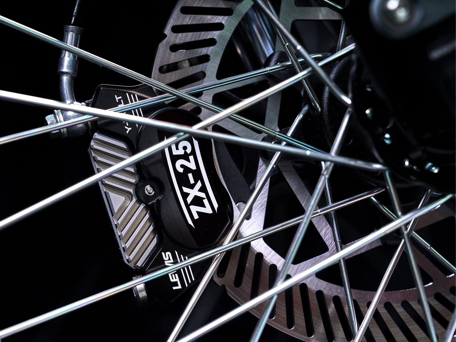 Surge V front brake caliper through the spokes
